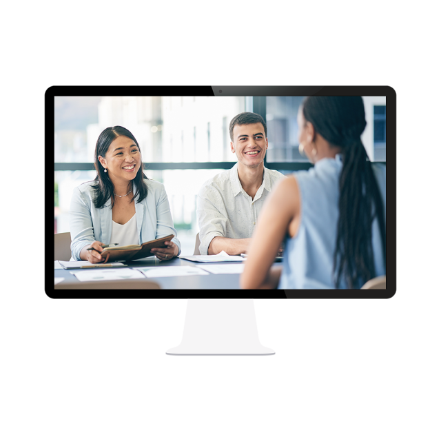 A young woman sits with her back to us with resume on the table, across from a woman and man in an interview 